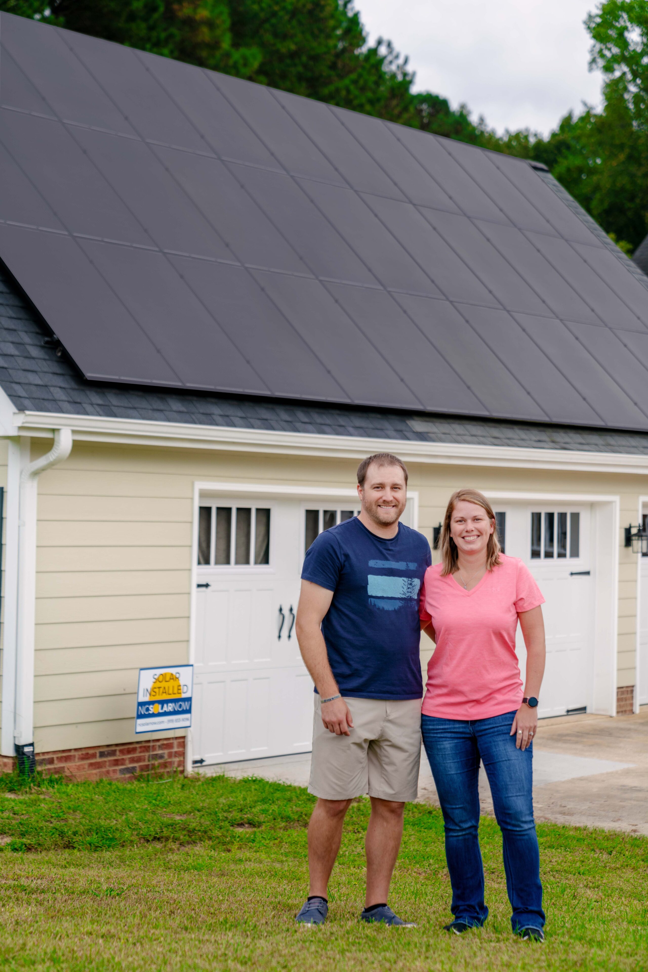 Justin Fox and wife in front of solar panels